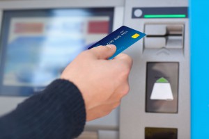 33954782 - man hand puts credit card into atm