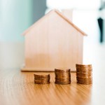 House and stacks of coins